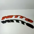 Наклейки на шины NITTO оранжевые. Клей в комплекте. Резиновые буквы для колес авто, надписи спортивные на диски и резину.